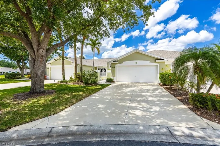Single story home with an attached garage, concrete driveway, and stucco siding