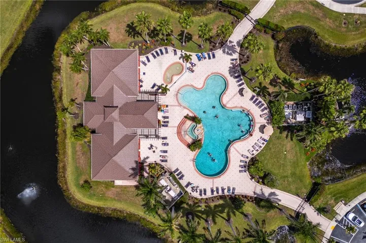Birds eye view of property with a water view