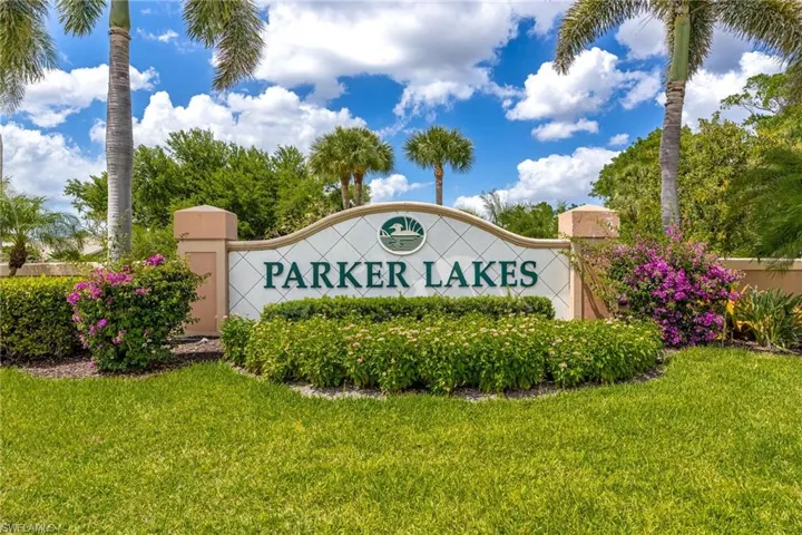 Community / neighborhood sign featuring a lawn