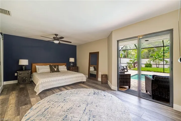 Interior space featuring wood-finish flooring, a contemporary ceiling fan, and direct access to an outdoor area via sliding glass doors