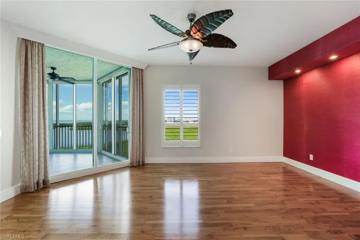 Sizable primary bedroom with sunset and water vistas.