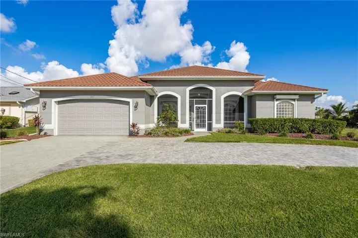 Mediterranean / spanish-style house featuring a garage and a front lawn