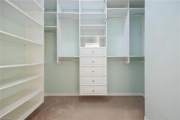 Master bedroom closet with custom closet organizer