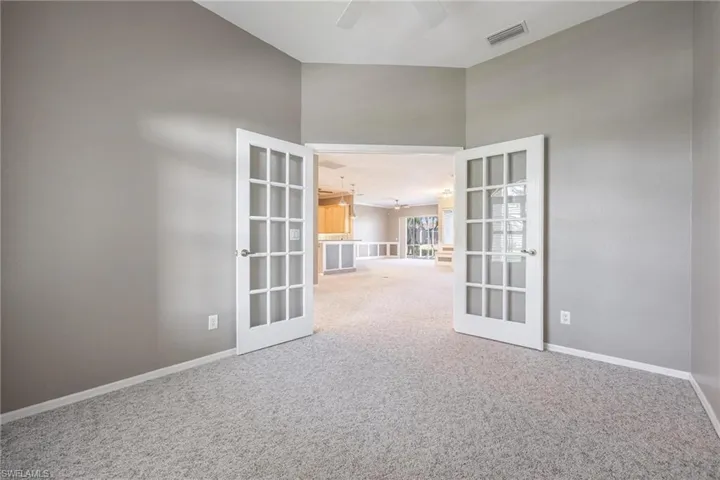 Den/ Office with  french doors, and high vaulted ceiling