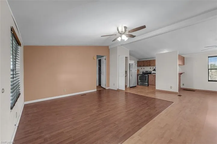 Unfurnished living room with a ceiling fan and light wood-type flooring