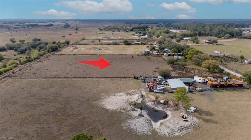 Aerial view of property and surrounding area featuring rural landscape