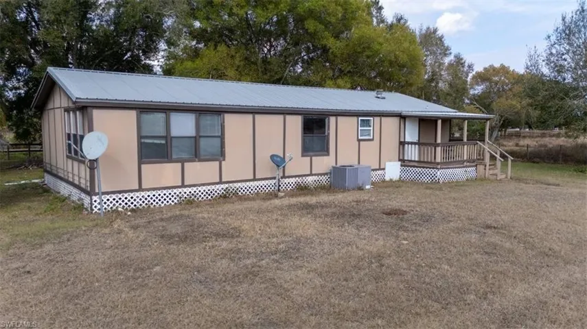 View of front of house featuring a deck and a metal roof