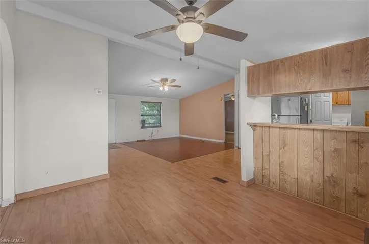 Unfurnished living room with light wood-style floors and ceiling fan