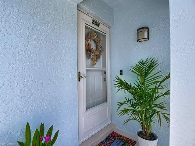 Entrance to property with stucco siding