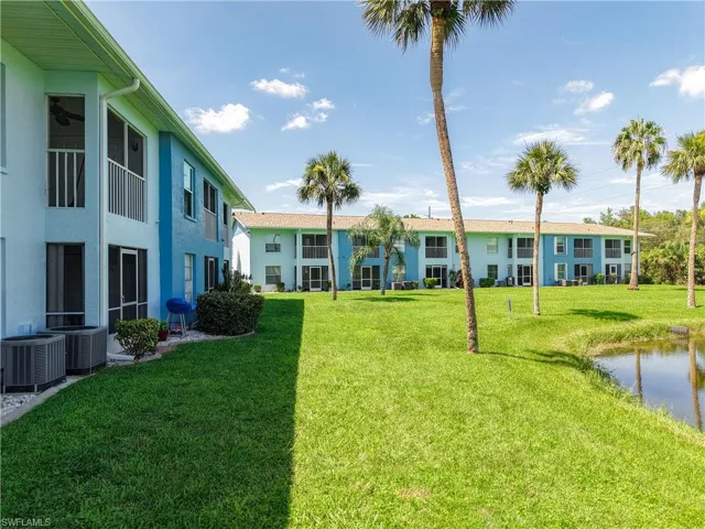 View of grassy yard with a water view
