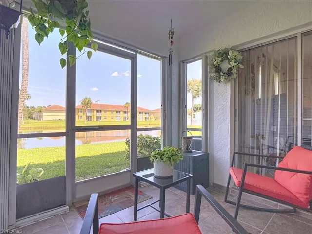 Sunroom featuring a water view