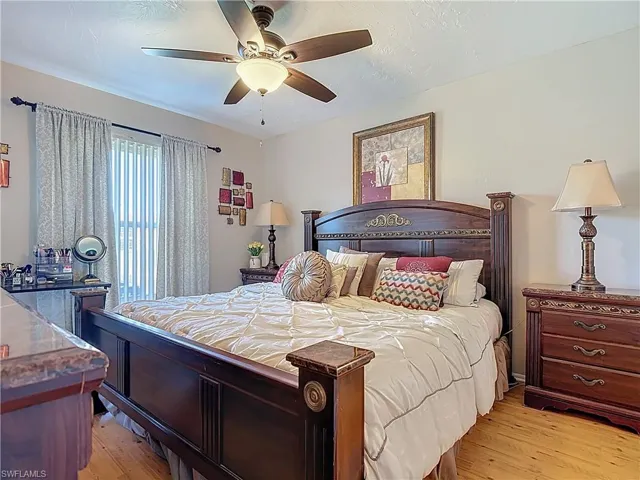 Bedroom with light wood finished floors and ceiling fan