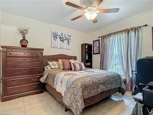 Bedroom featuring light tile patterned floors and a ceiling fan