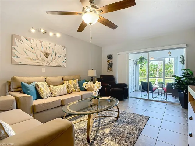 Living room with light tile patterned flooring and a ceiling fan