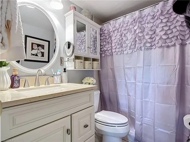 Full bathroom with vanity and curtained shower
