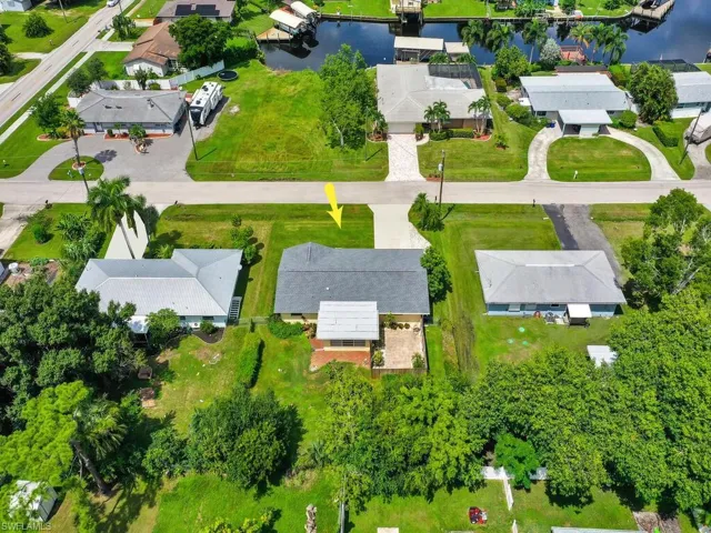 Birds eye view of property featuring a water view and a residential view