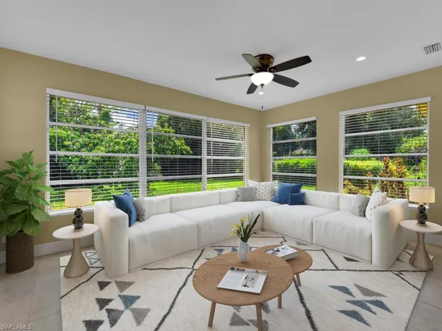 Sunroom / solarium featuring an outdoor living space, visible vents, and a ceiling fan