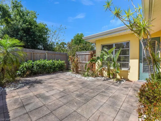 View of patio featuring fence