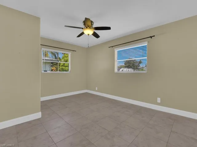 Unfurnished room with baseboards and ceiling fan
