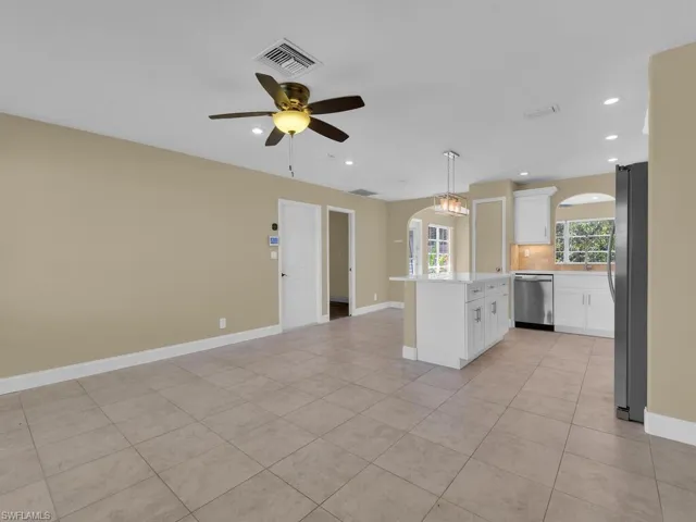 Kitchen featuring white cabinetry, light countertops, backsplash, visible vents, and appliances with stainless steel finishes
