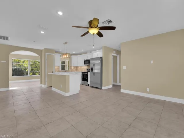 Kitchen with visible vents, light countertops, ceiling fan, and stainless steel appliances