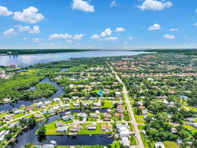 Drone / aerial view with a residential view and a water view
