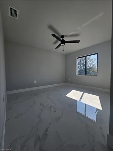 Spare room with ceiling fan