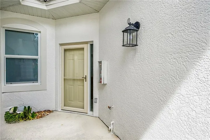 View of exterior entry with stucco siding