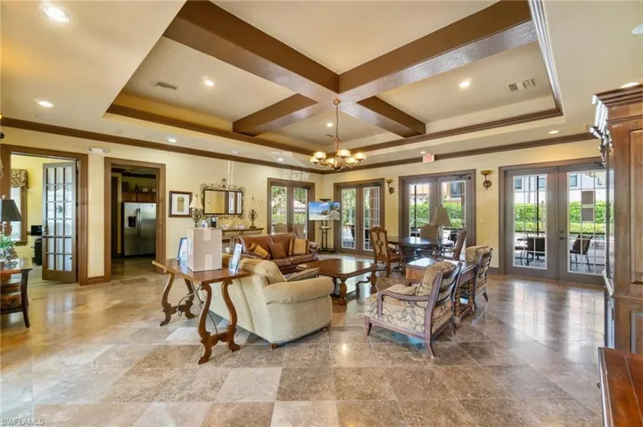 Living room with baseboards, french doors, visible vents, and ornamental molding