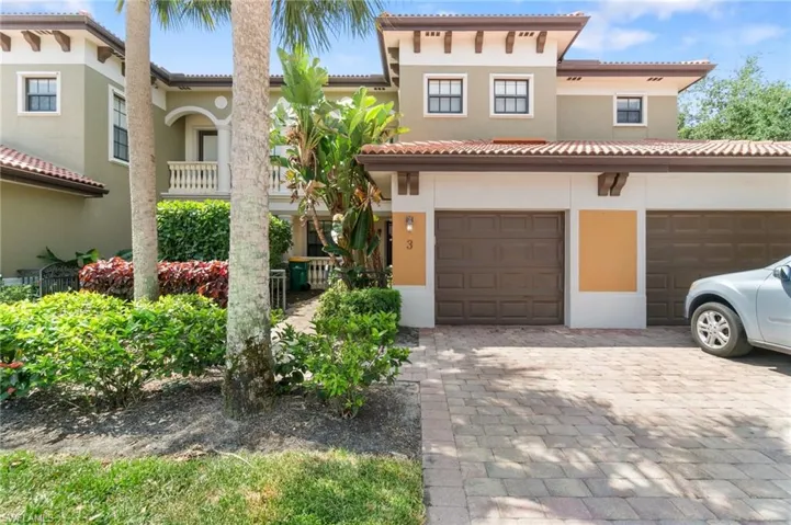 Mediterranean / spanish-style home featuring stucco siding, decorative driveway, and a garage
