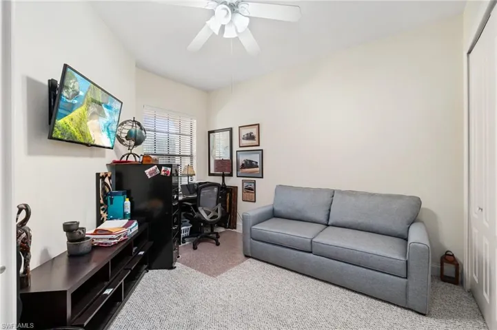 Office space featuring carpet floors and a ceiling fan