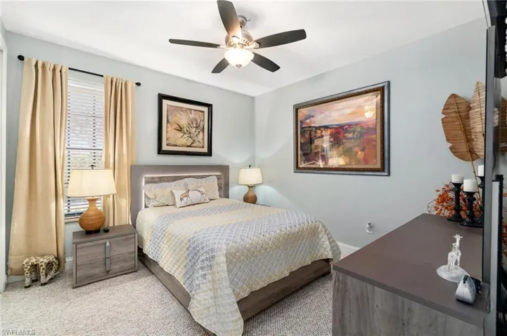 Bedroom featuring carpet flooring, baseboards, and ceiling fan
