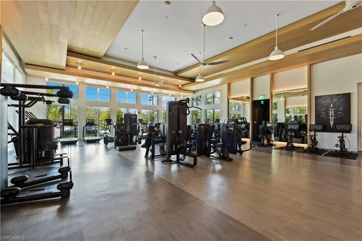 Gym with a tray ceiling and wood ceiling