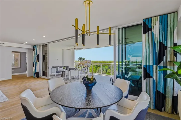 Dining space featuring light wood finished floors, a ceiling fan, and recessed lighting