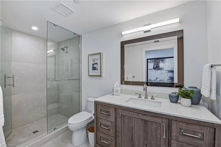 Bathroom featuring a stall shower and vanity