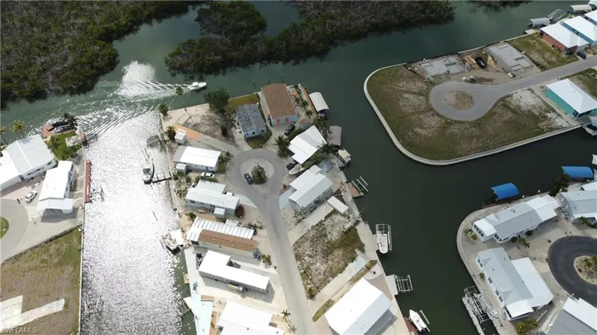 Aerial overview of property's location featuring a nearby body of water and nearby suburban area