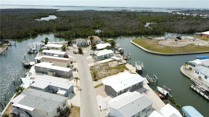 Aerial perspective of suburban area featuring a nearby body of water