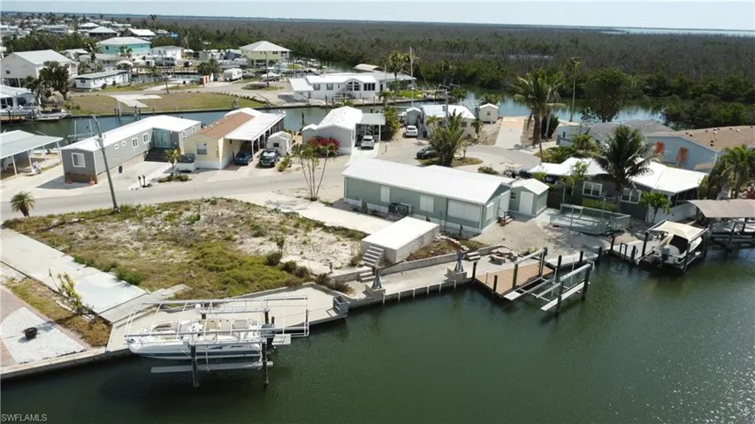 Aerial view of residential area featuring a large body of water