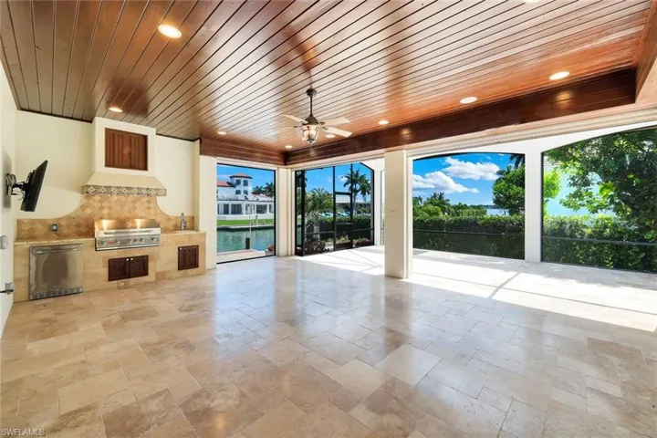 Covered area off of pool with built-in kitchen