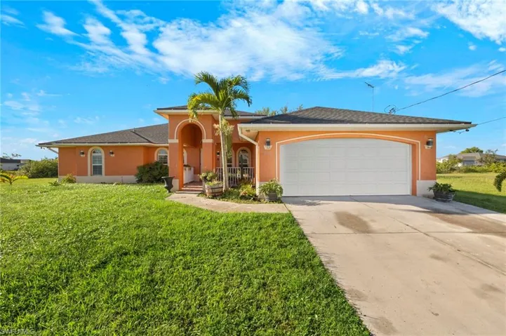 Stucco exterior with a two-car garage and a paved driveway