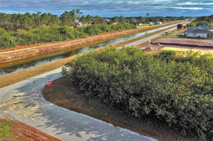 Surrounding community featuring a water view and view of scattered trees