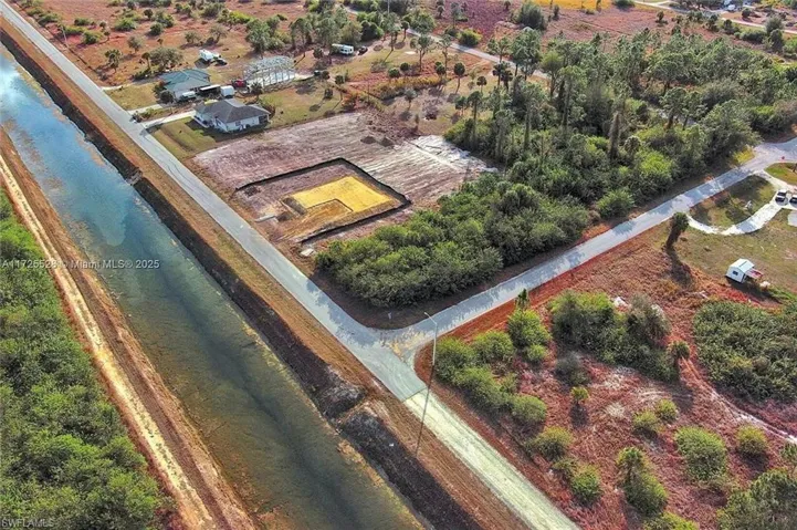 Aerial view of property and surrounding area featuring rural landscape