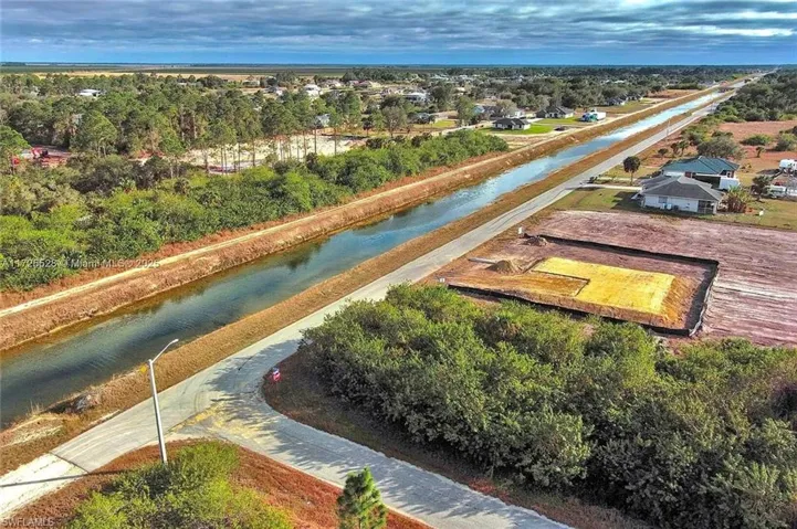 Aerial view of residential area featuring a large body of water