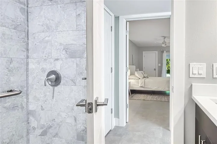 Bathroom featuring vanity, a walk-in shower, a ceiling and ensuite bath