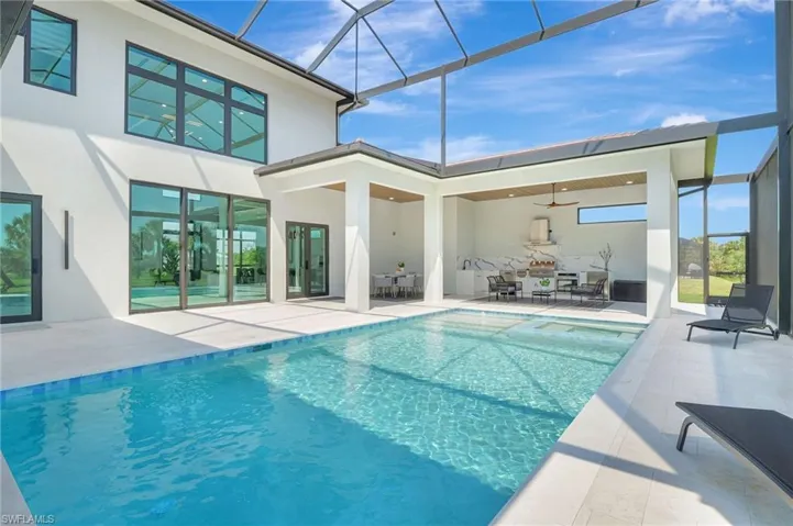 Outdoor pool with glass enclosure and a patio