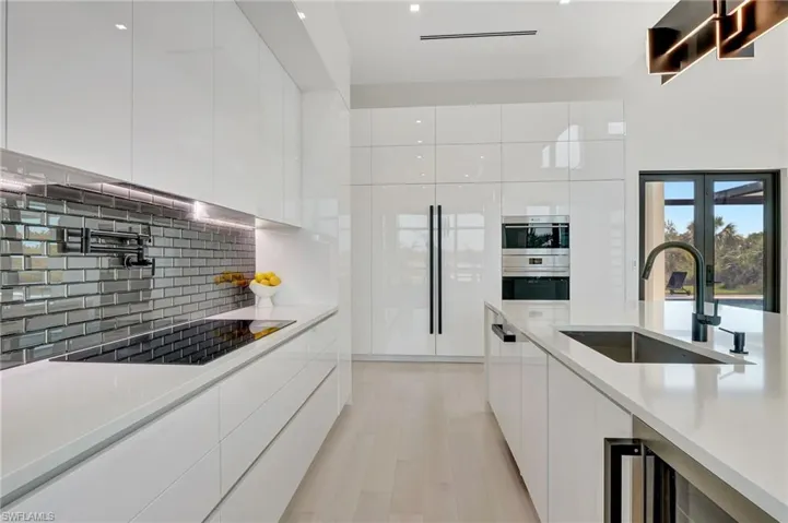 Kitchen featuring white cabinetry, a sink, and modern cabinets