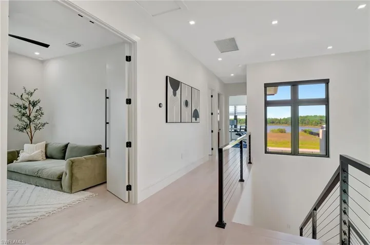 Corridor with baseboards, recessed lighting, an upstairs landing, light wood-style flooring, and visible vents