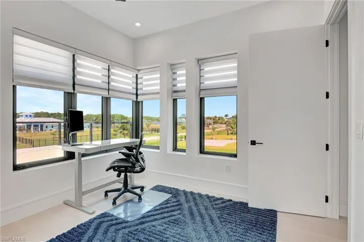 Office with recessed lighting, plenty of natural light, and baseboards