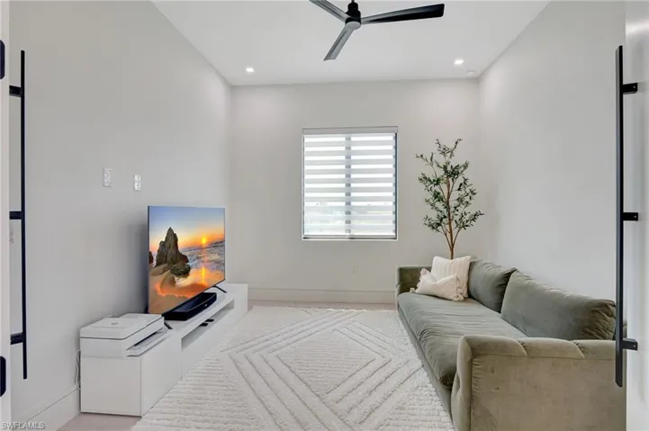 Living room with ceiling fan, recessed lighting, and baseboards