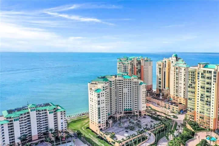 Birds eye view of property with a water view